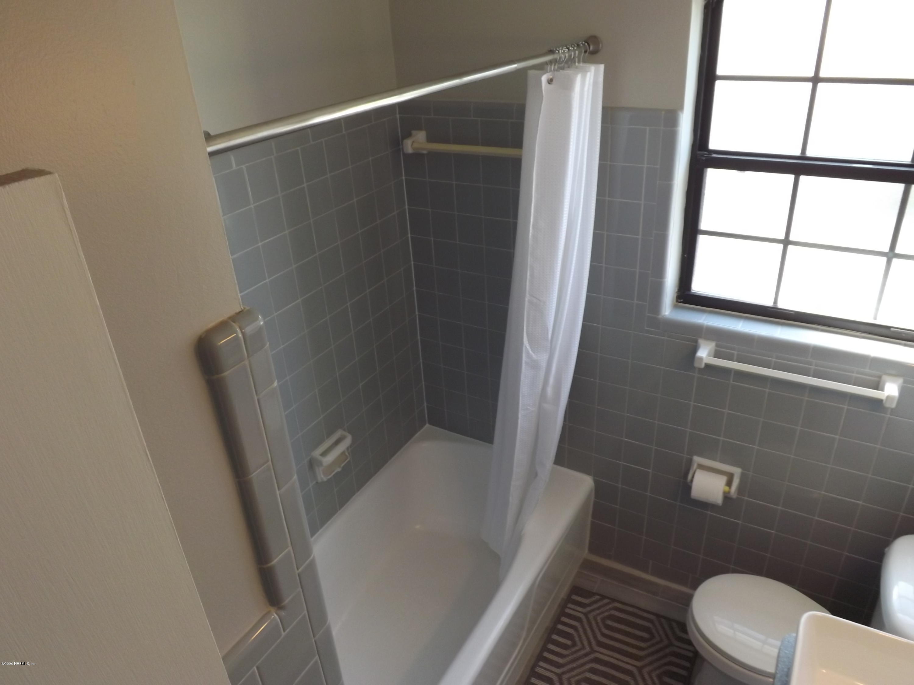 3565 Rogero Road Jacksonville, FL 32277 - Photo 24 of 74 a bathroom with a toilet and a shower