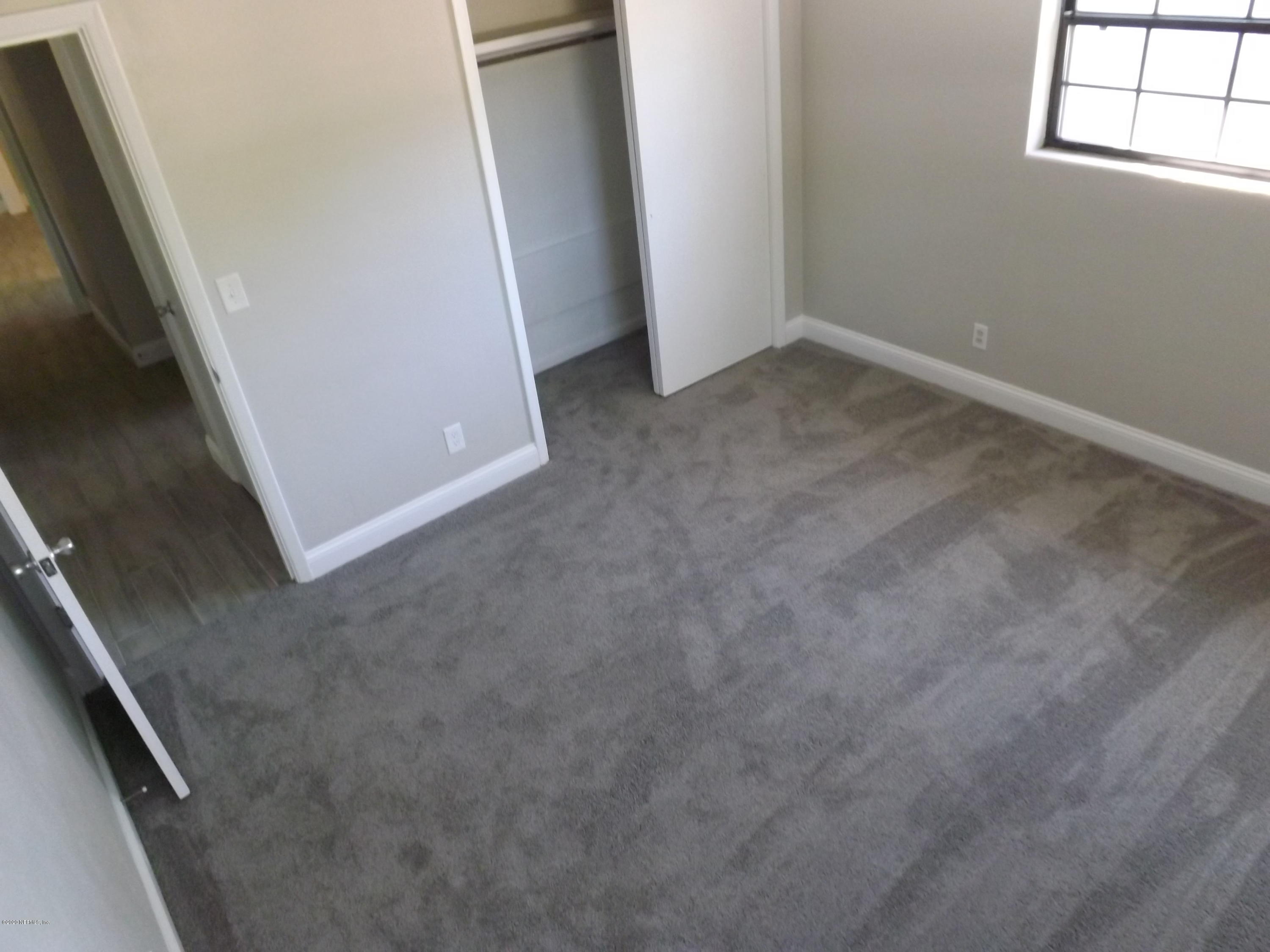 3565 Rogero Road Jacksonville, FL 32277 - Photo 29 of 74 an empty room with windows