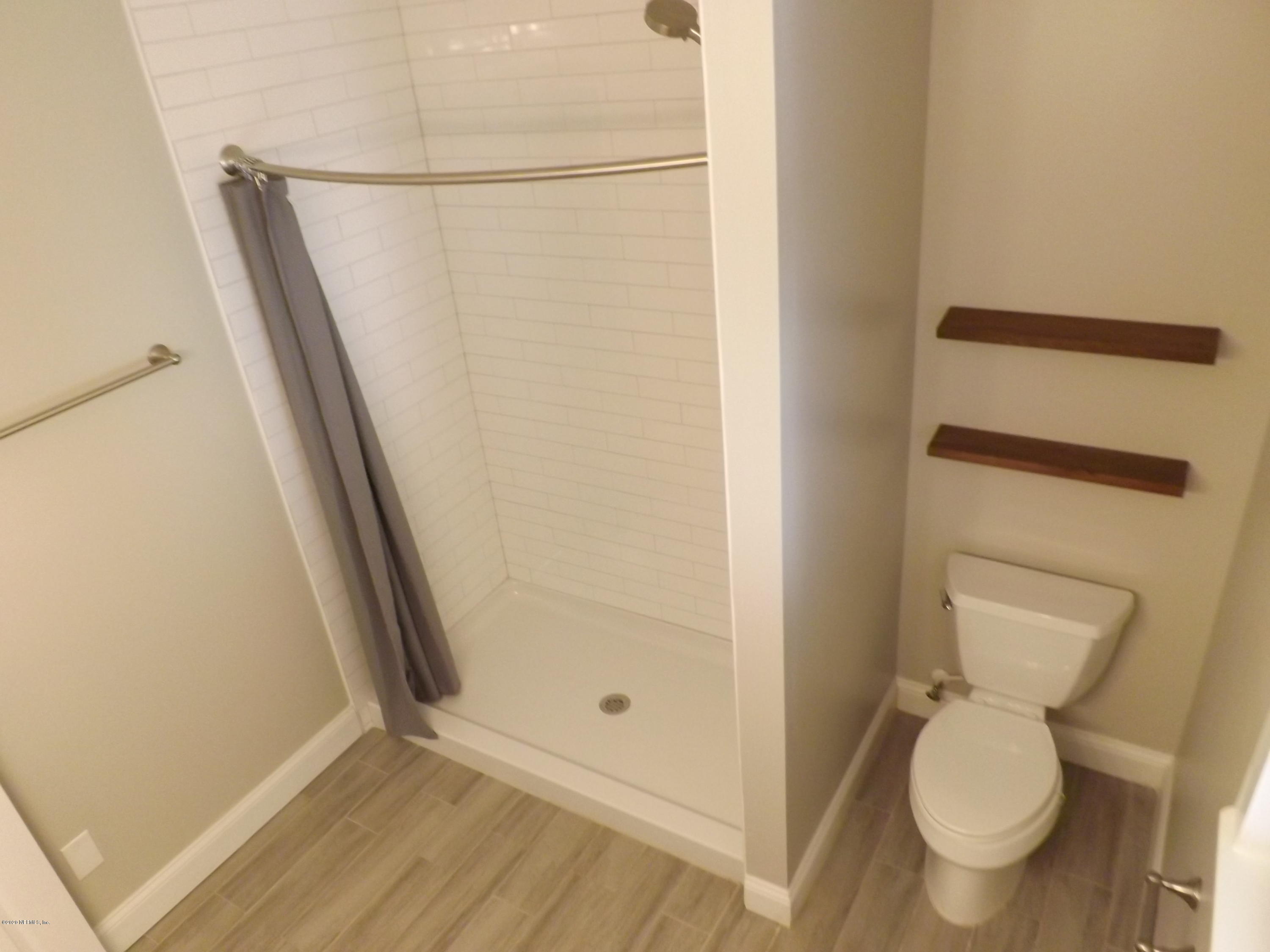 3565 Rogero Road Jacksonville, FL 32277 - Photo 3 of 74 a bathroom with a toilet and a shower