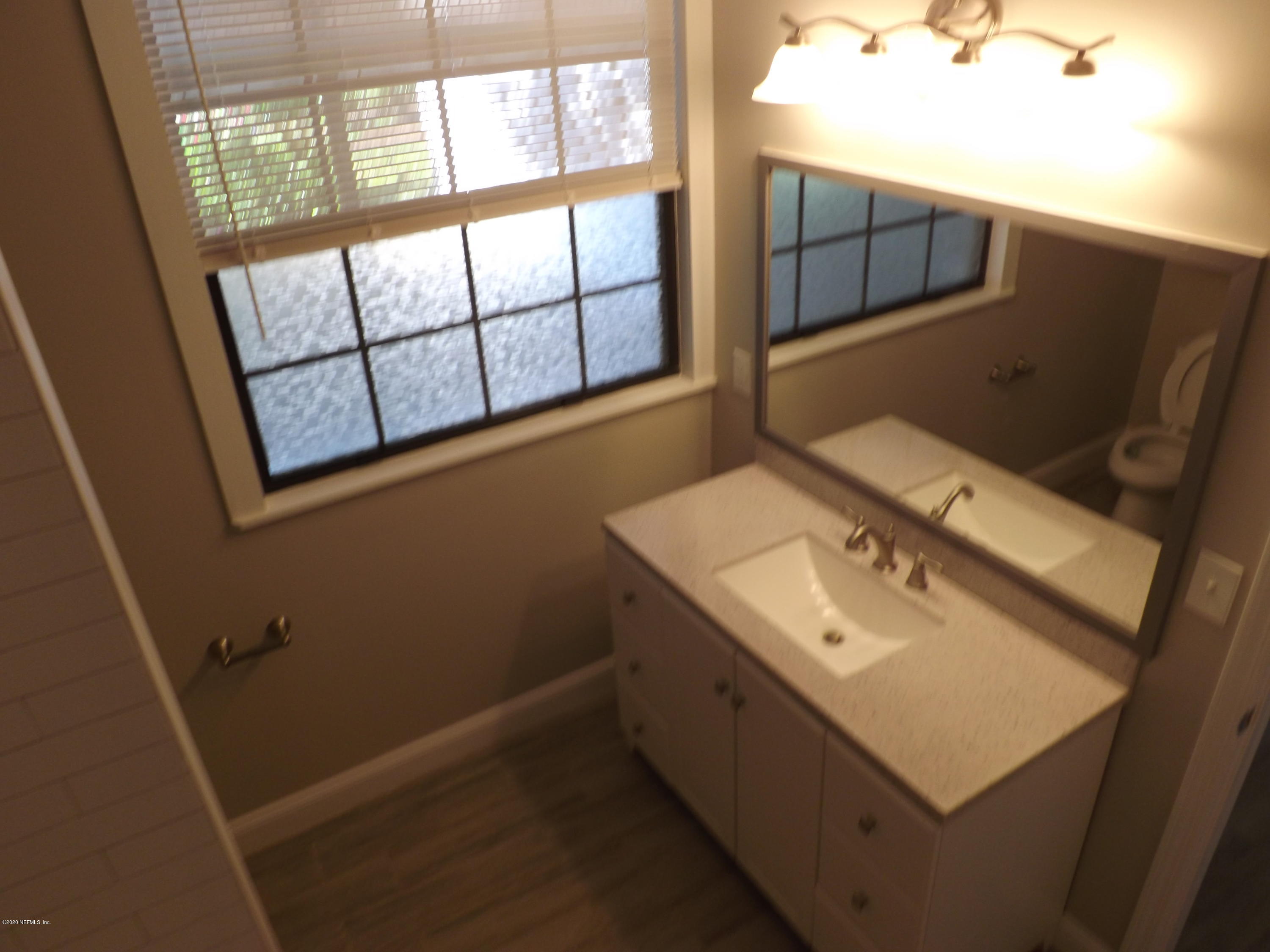 3565 Rogero Road Jacksonville, FL 32277 - Photo 5 of 74 a bathroom with a sink and a mirror