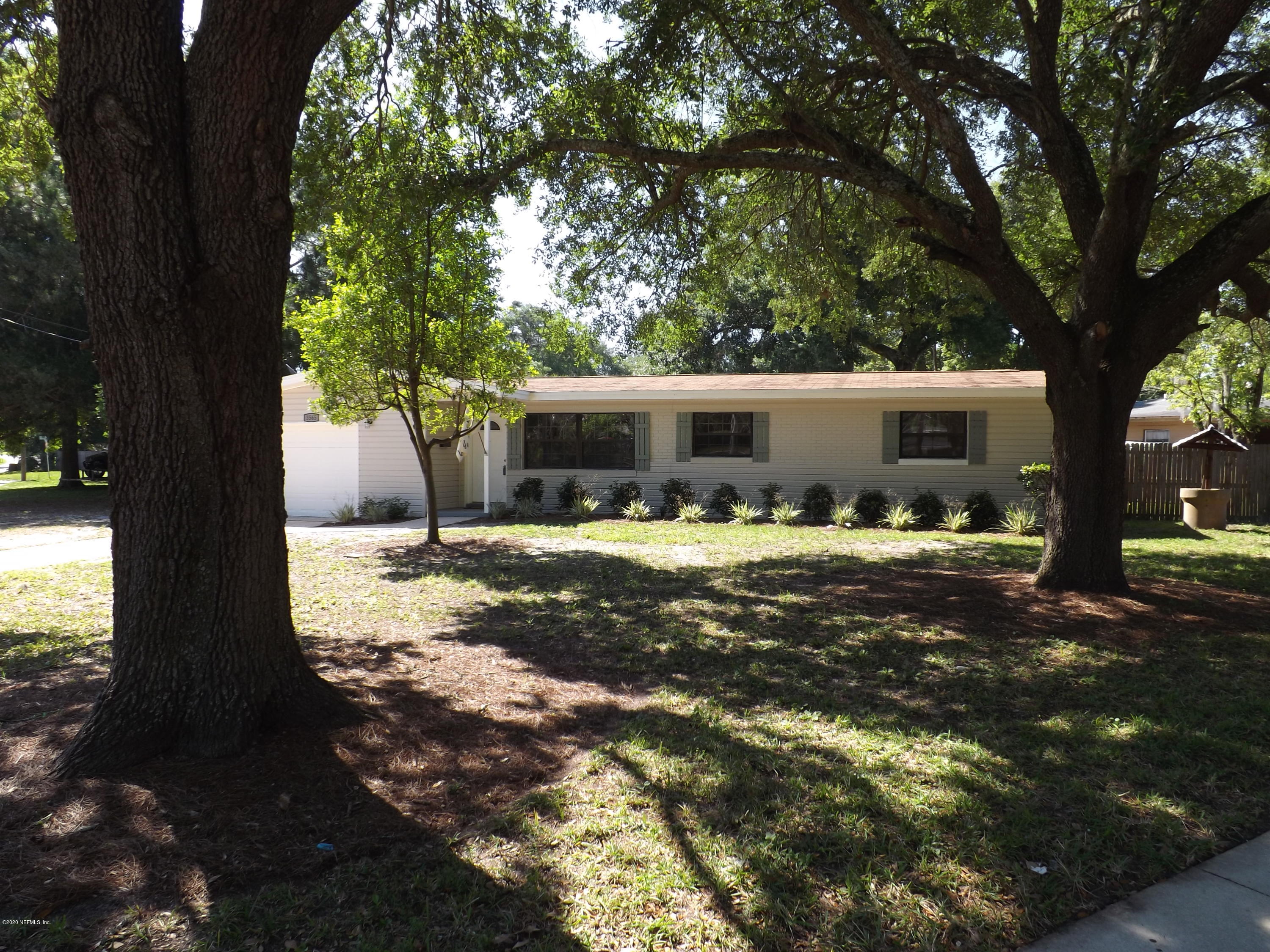 3565 Rogero Road Jacksonville, FL 32277 - Photo 51 of 74 a view of house with yard outdoor seating and covered with trees