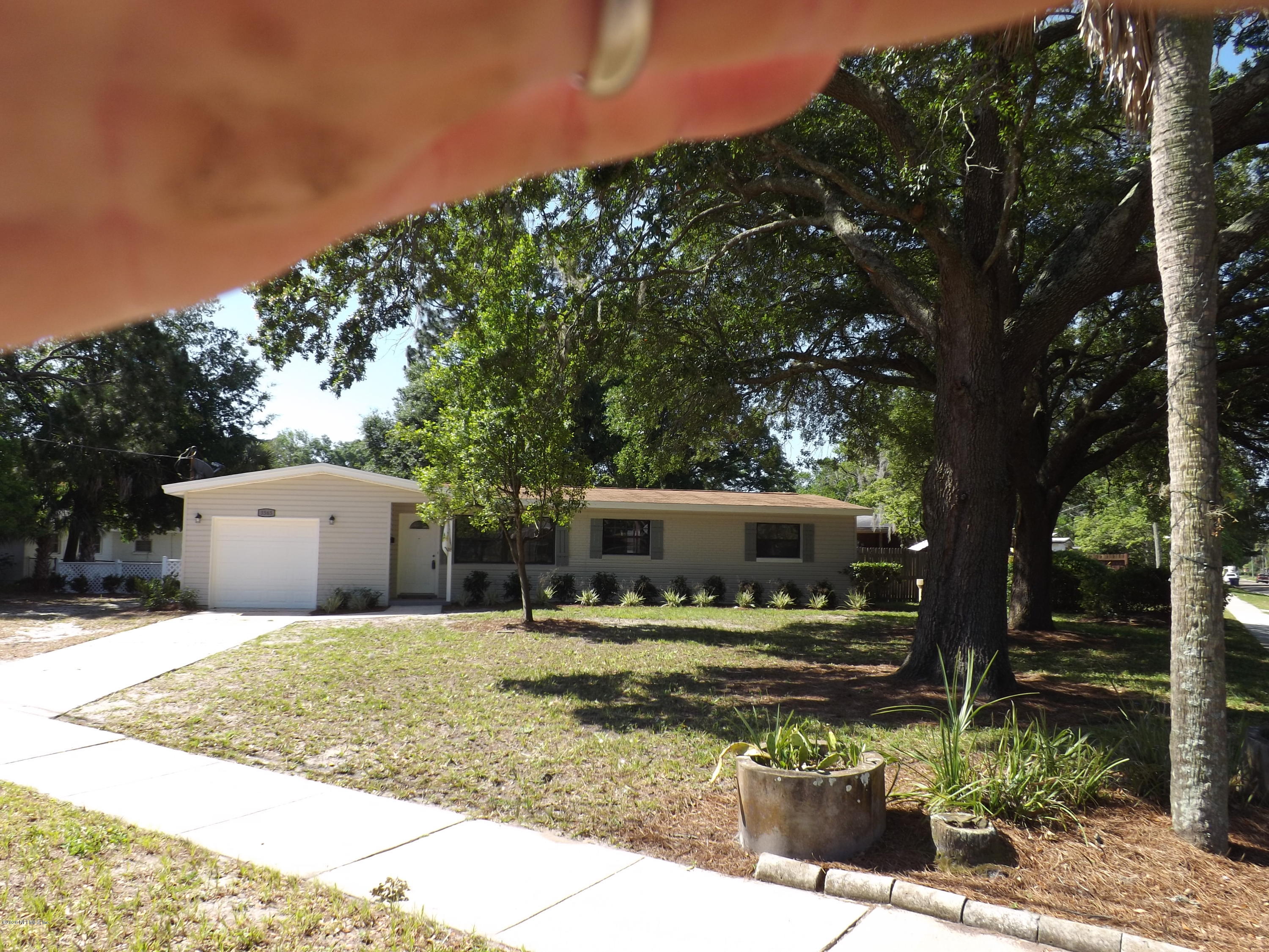 3565 Rogero Road Jacksonville, FL 32277 - Photo 53 of 74 a backyard of a house with yard and outdoor seating