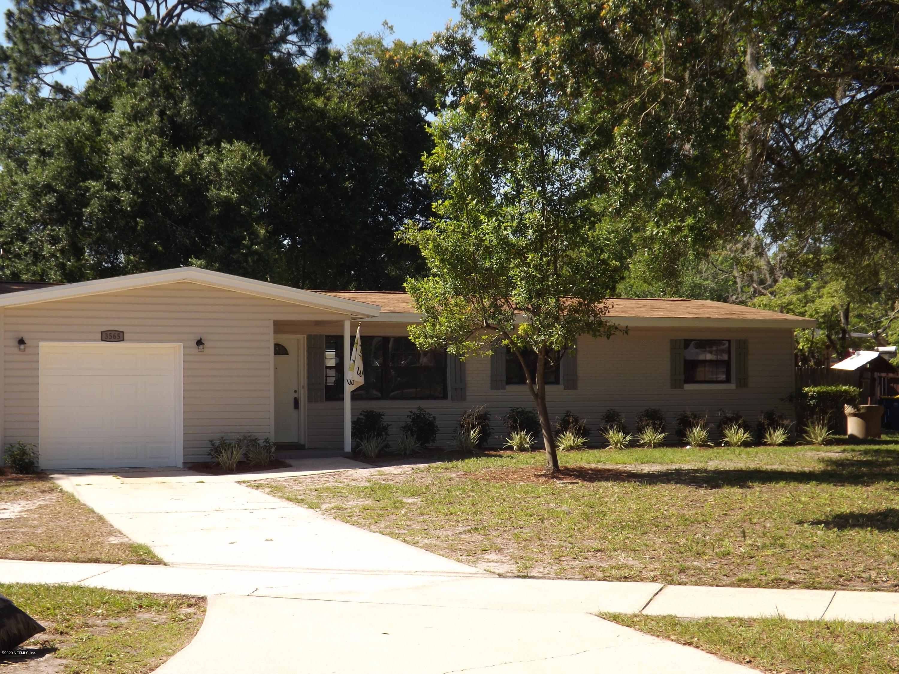 3565 Rogero Road Jacksonville, FL 32277 - Photo 55 of 74 a front view of a house with a yard
