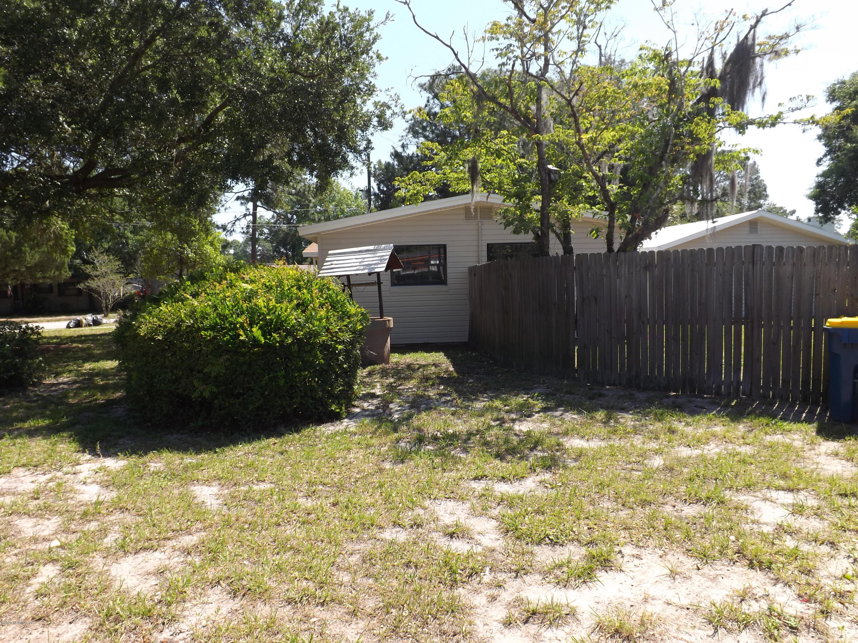 3565 Rogero Road Jacksonville, FL 32277 - Photo 70 of 74 a house with trees in front of it