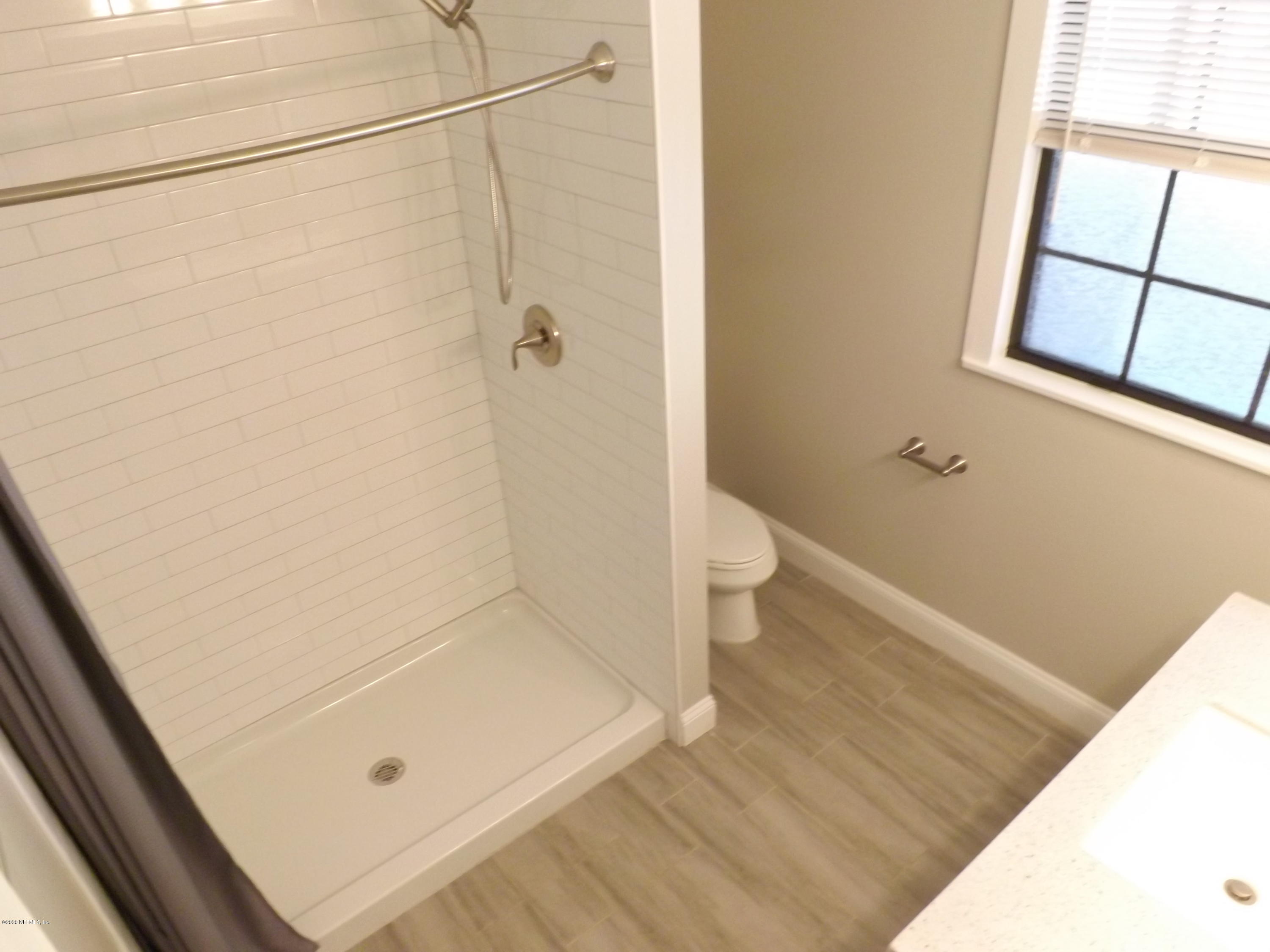 3565 Rogero Road Jacksonville, FL 32277 - Photo 7 of 74 a bathroom with a sink and a vanity