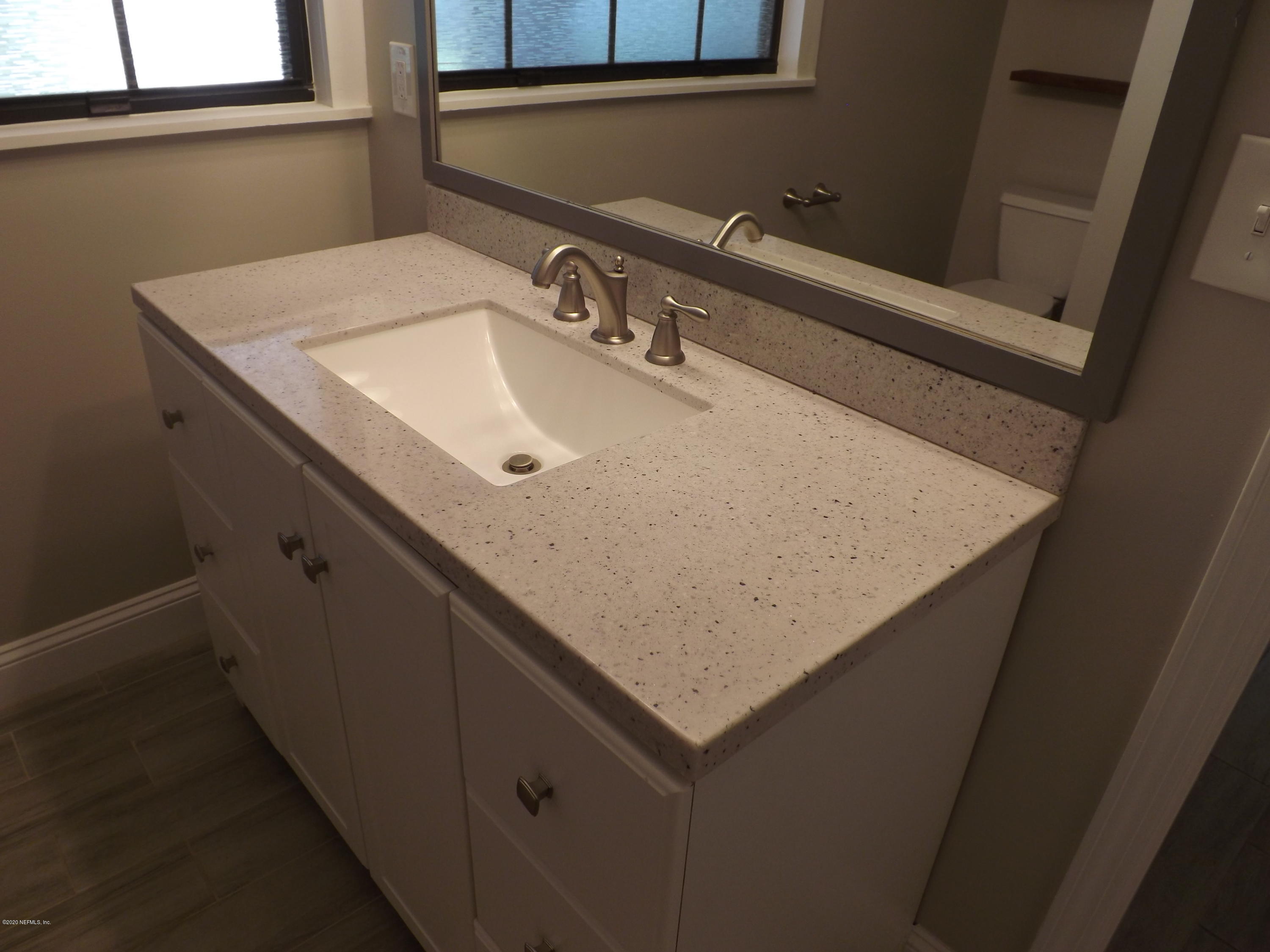 3565 Rogero Road Jacksonville, FL 32277 - Photo 9 of 74 a bathroom with a sink and a mirror
