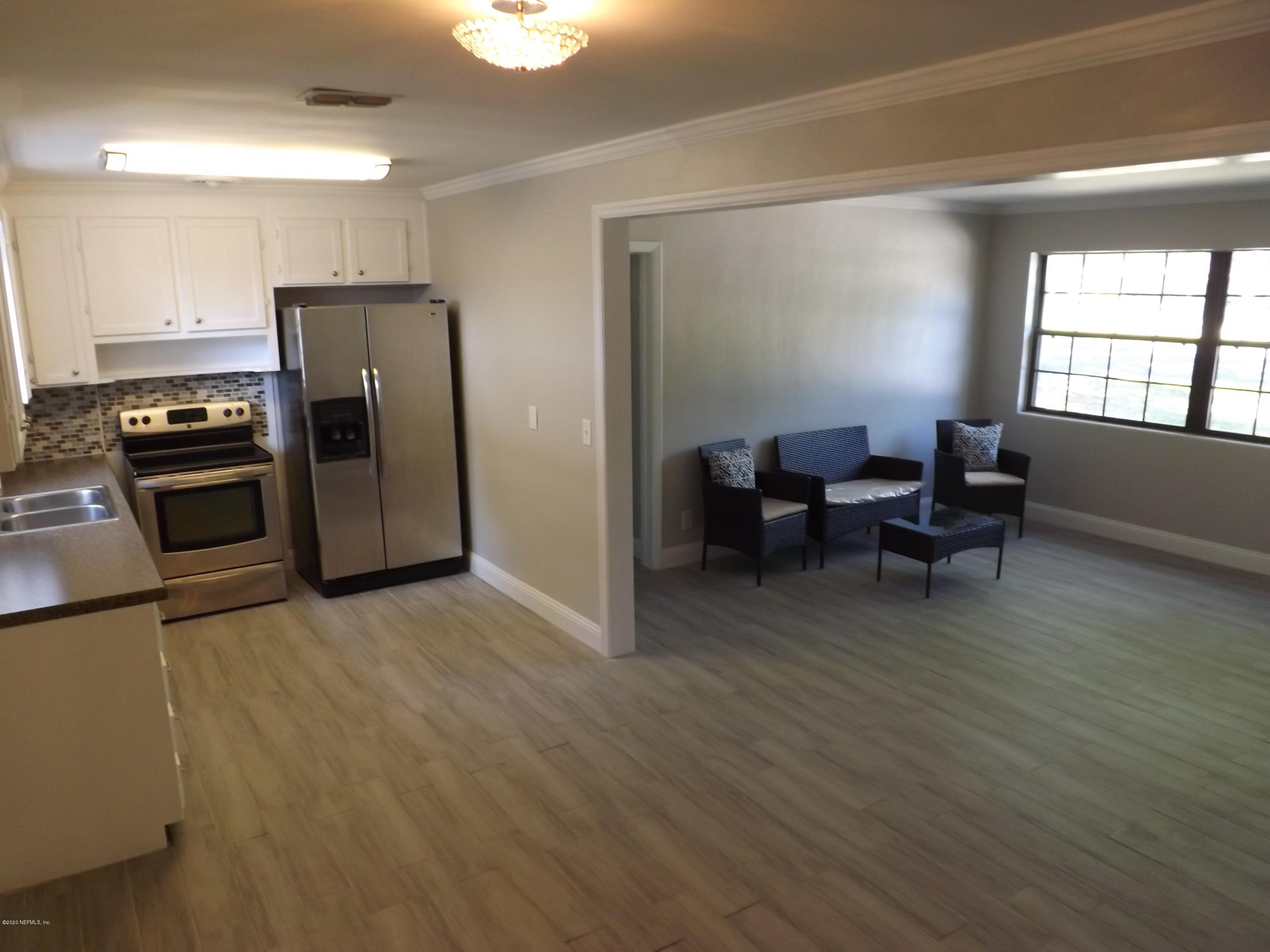 3565 Rogero Road Jacksonville, FL 32277 - Photo 10 of 74 a open kitchen with stainless steel appliances granite countertop a refrigerator and a stove top oven