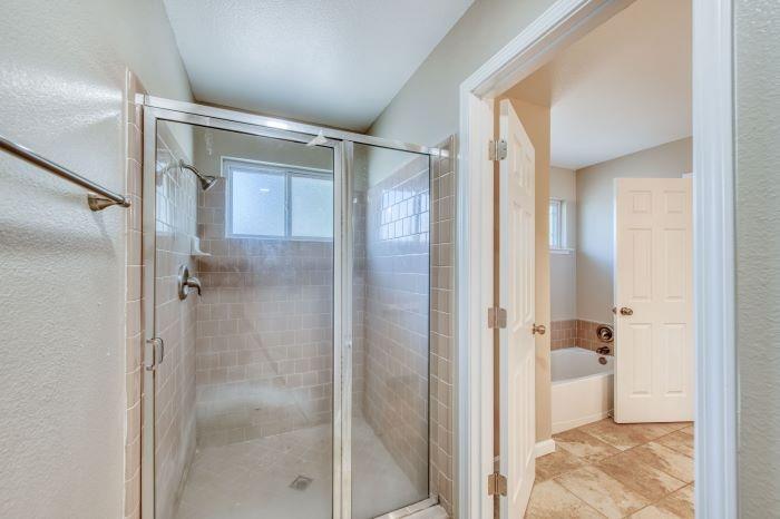 6153 Big Oak Road Sanger, CA 93657 - Photo 13 of 23 a bathroom with a glass shower door