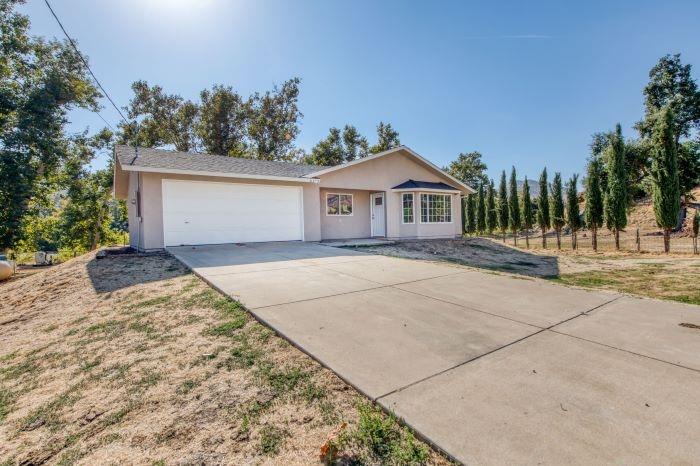 6153 Big Oak Road Sanger, CA 93657 - Photo 2 of 23 a view of a house with a yard
