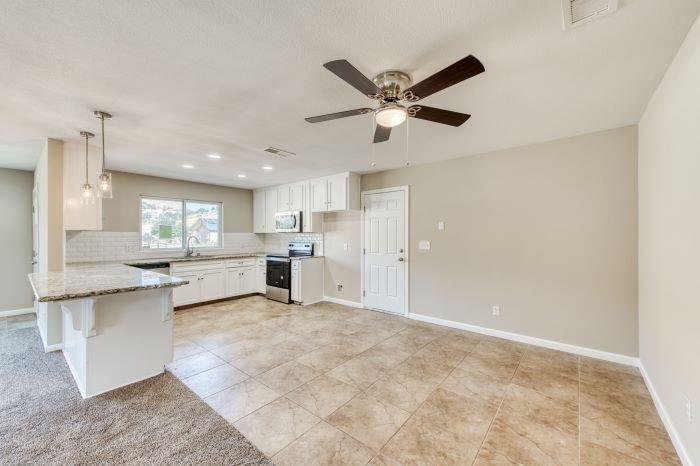 6153 Big Oak Road Sanger, CA 93657 - Photo 6 of 23 a view of a kitchen with kitchen island a sink stainless steel appliances and cabinets