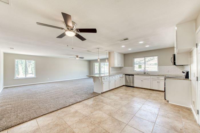 6153 Big Oak Road Sanger, CA 93657 - Photo 7 of 23 a view of a kitchen with a sink and microwave