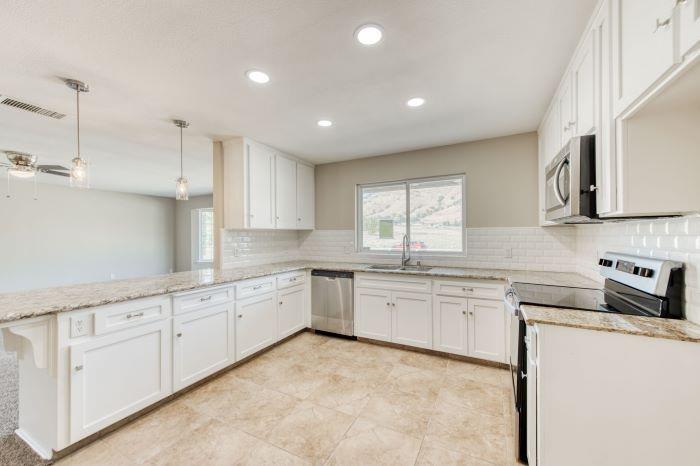 6153 Big Oak Road Sanger, CA 93657 - Photo 8 of 23 a large kitchen with cabinets