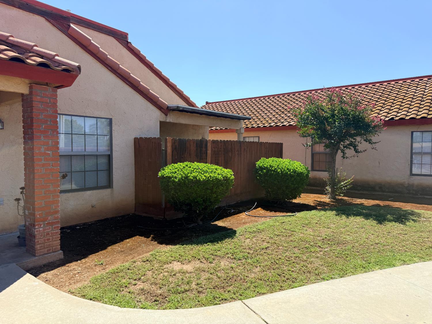 1405 East Cypress Avenue Reedley, CA 93654 - Photo 7 of 29 a view of a backyard with potted plants