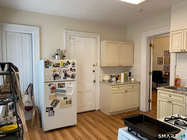 a kitchen with stainless steel appliances granite countertop a refrigerator and a sink
