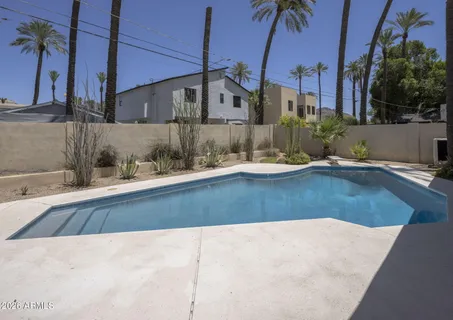 a view of a swimming pool with a yard