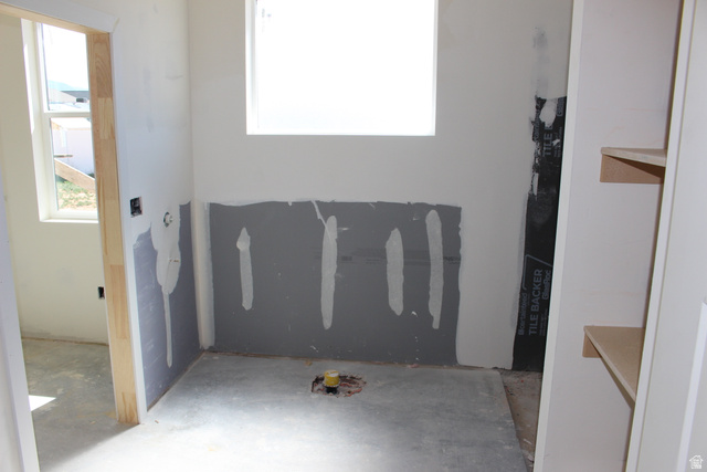 4933 East Remington Road Cedar City, UT 84721 - Photo 19 of 33 Unfinished interior space featuring a window, prepped wall panels, and built-in shelving