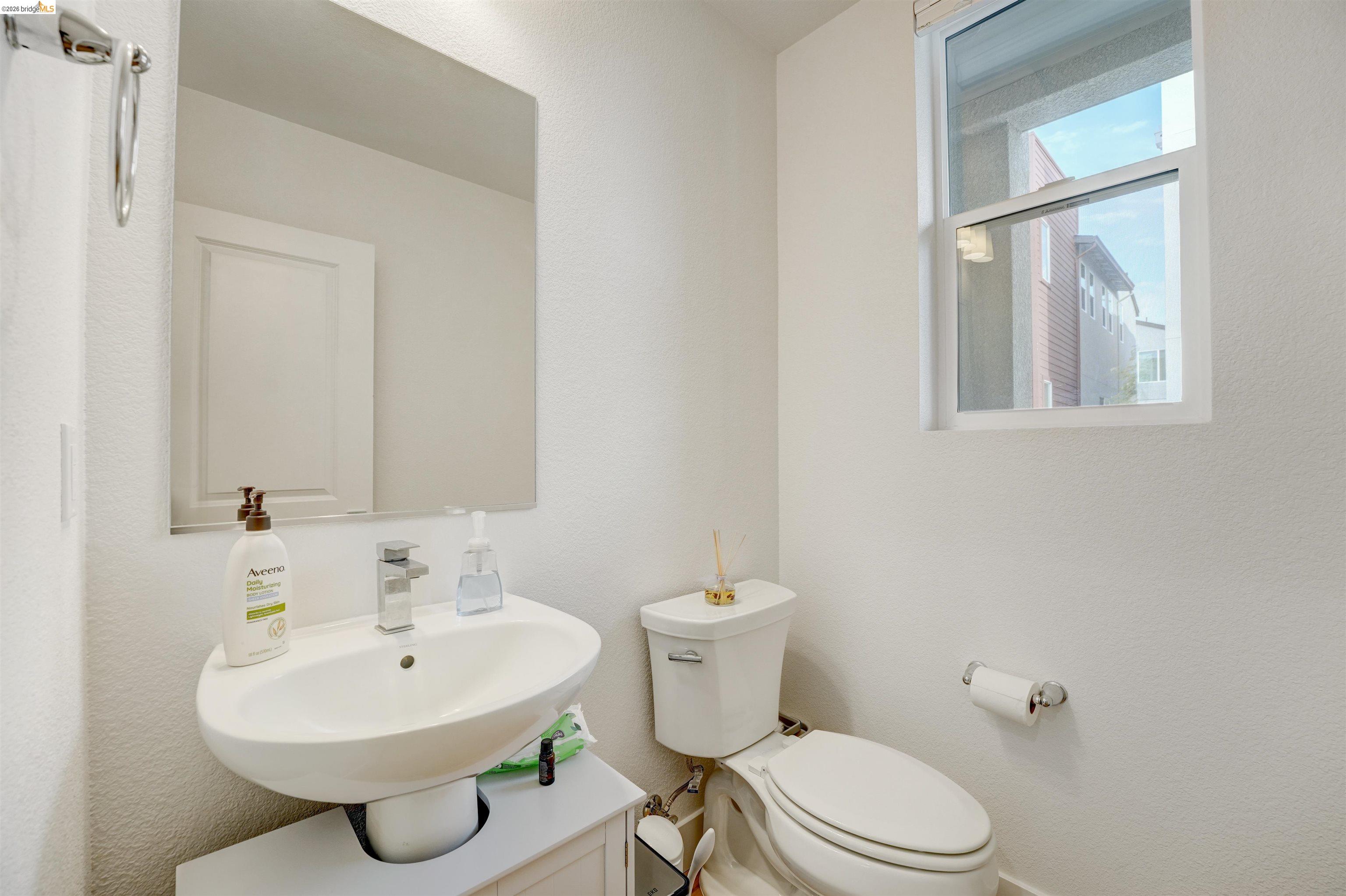 7101 Melon Court San Ramon, CA 94583 - Photo 15 of 58 a bathroom with a sink a toilet and mirror