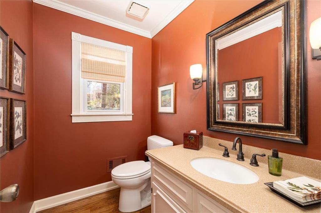 4890 Forestglade Court Smoke Rise, GA 30087 - Photo 16 of 50 a bathroom with a granite countertop toilet sink and mirror