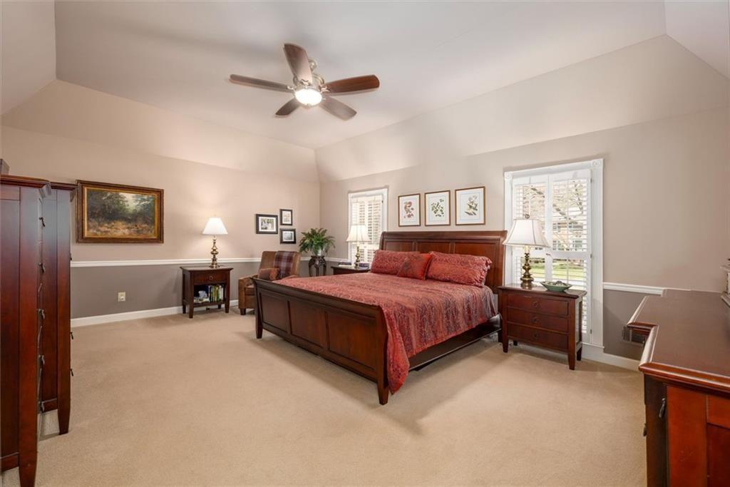 4890 Forestglade Court Smoke Rise, GA 30087 - Photo 17 of 50 a bedroom with a bed and furniture