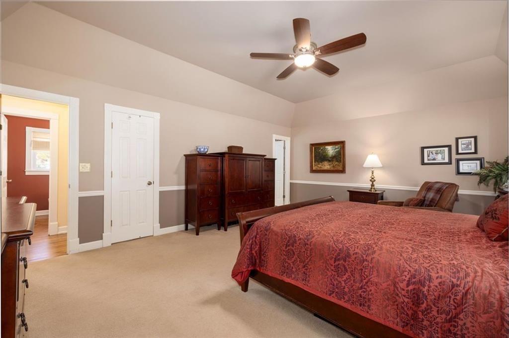 4890 Forestglade Court Smoke Rise, GA 30087 - Photo 18 of 50 a bedroom with a bed and a refrigerator