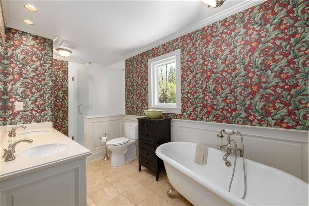 4890 Forestglade Court Smoke Rise, GA 30087 - Photo 19 of 50 a bathroom with a sink toilet and bathtub