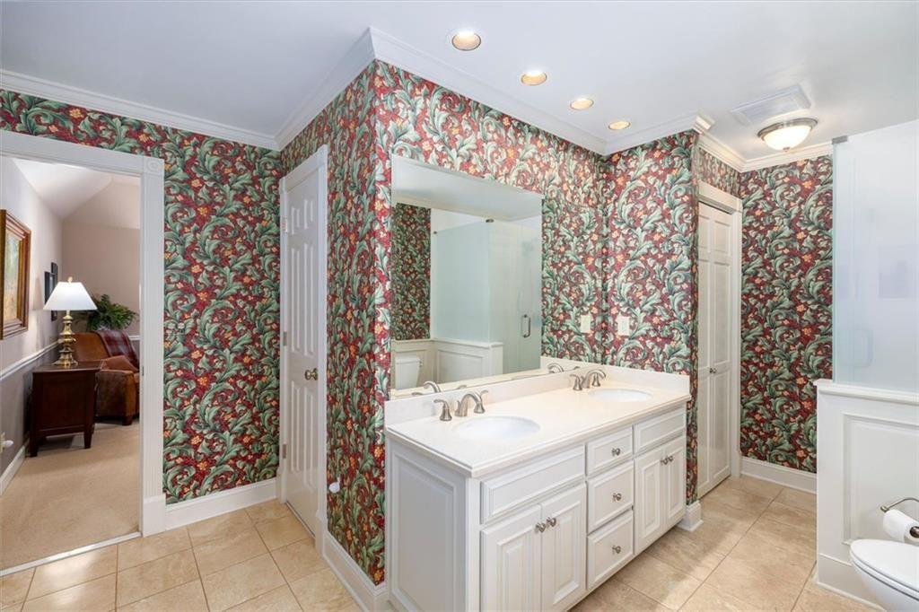 4890 Forestglade Court Smoke Rise, GA 30087 - Photo 20 of 50 a bathroom with a double vanity sink mirror and shower
