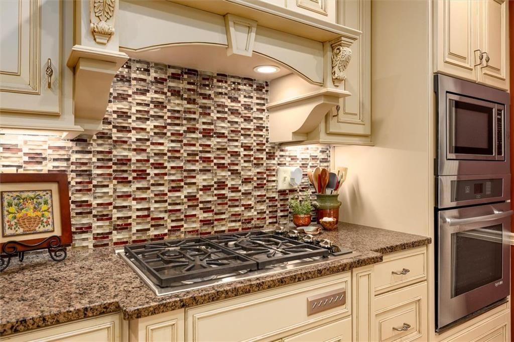 4890 Forestglade Court Smoke Rise, GA 30087 - Photo 22 of 50 a stove top oven sitting inside of a kitchen
