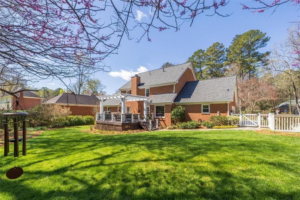 4890 Forestglade Court Smoke Rise, GA 30087 - Photo 3 of 50 a view of a house with a yard and sitting area