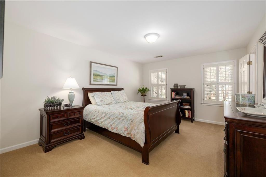 4890 Forestglade Court Smoke Rise, GA 30087 - Photo 31 of 50 a spacious bedroom with a bed and a windows