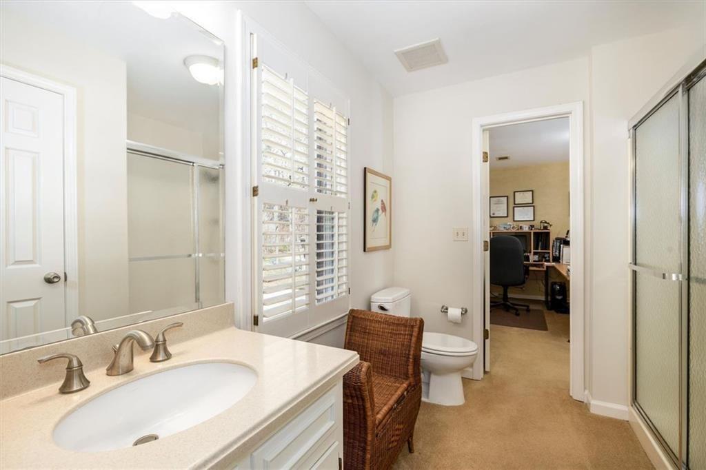 4890 Forestglade Court Smoke Rise, GA 30087 - Photo 33 of 50 a en suite bathroom with a sink a toilet and shower