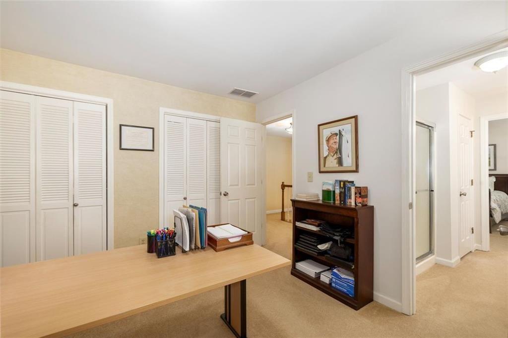 4890 Forestglade Court Smoke Rise, GA 30087 - Photo 35 of 50 a bedroom with a bed and a cabinets