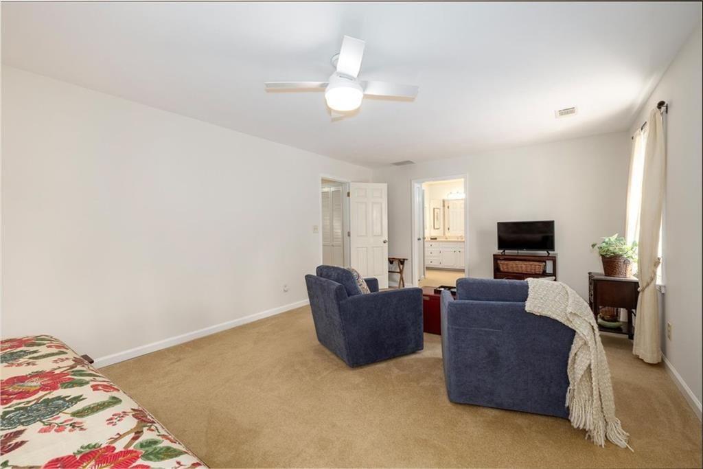 4890 Forestglade Court Smoke Rise, GA 30087 - Photo 37 of 50 a living room with furniture and a flat screen tv