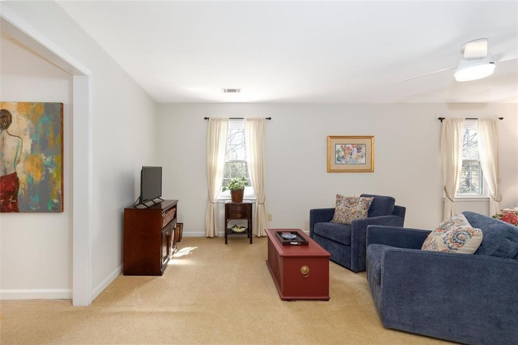 4890 Forestglade Court Smoke Rise, GA 30087 - Photo 38 of 50 a living room with furniture and a flat screen tv