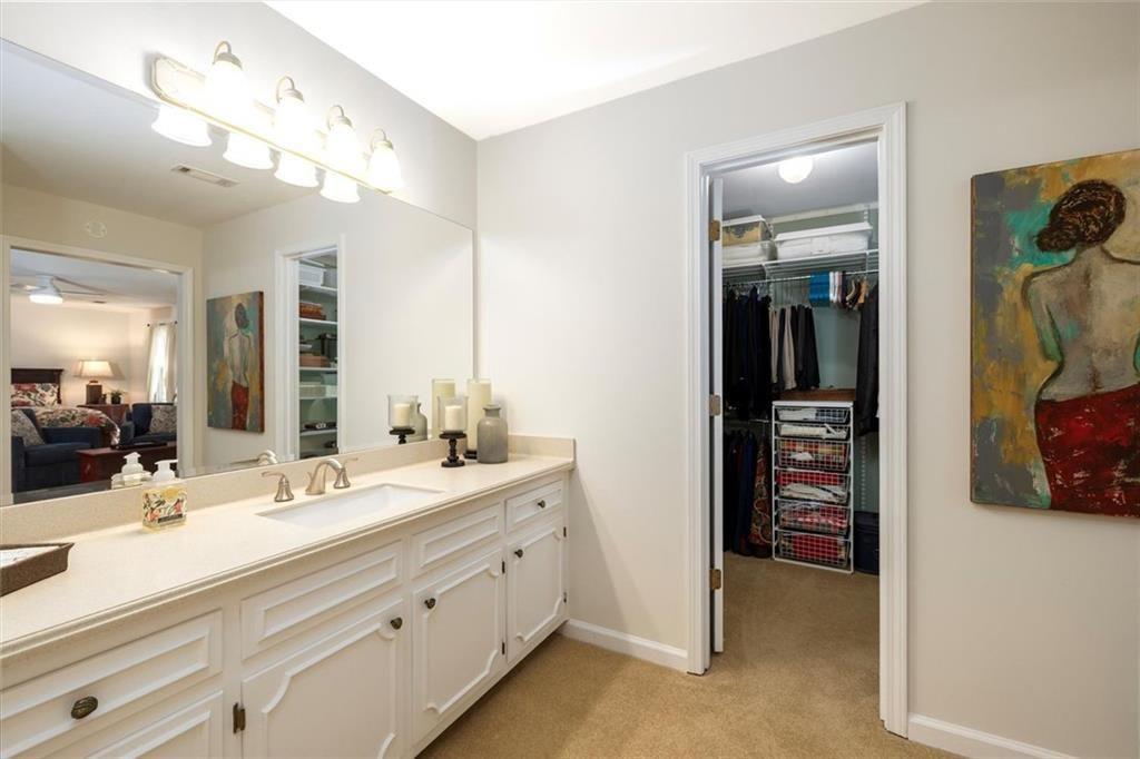 4890 Forestglade Court Smoke Rise, GA 30087 - Photo 39 of 50 a bathroom with a double vanity sink and a mirror