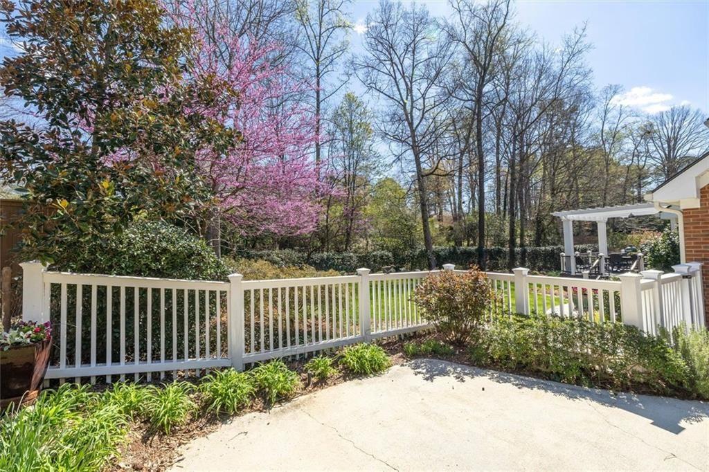 4890 Forestglade Court Smoke Rise, GA 30087 - Photo 43 of 50 a view of a house with a small yard and large trees