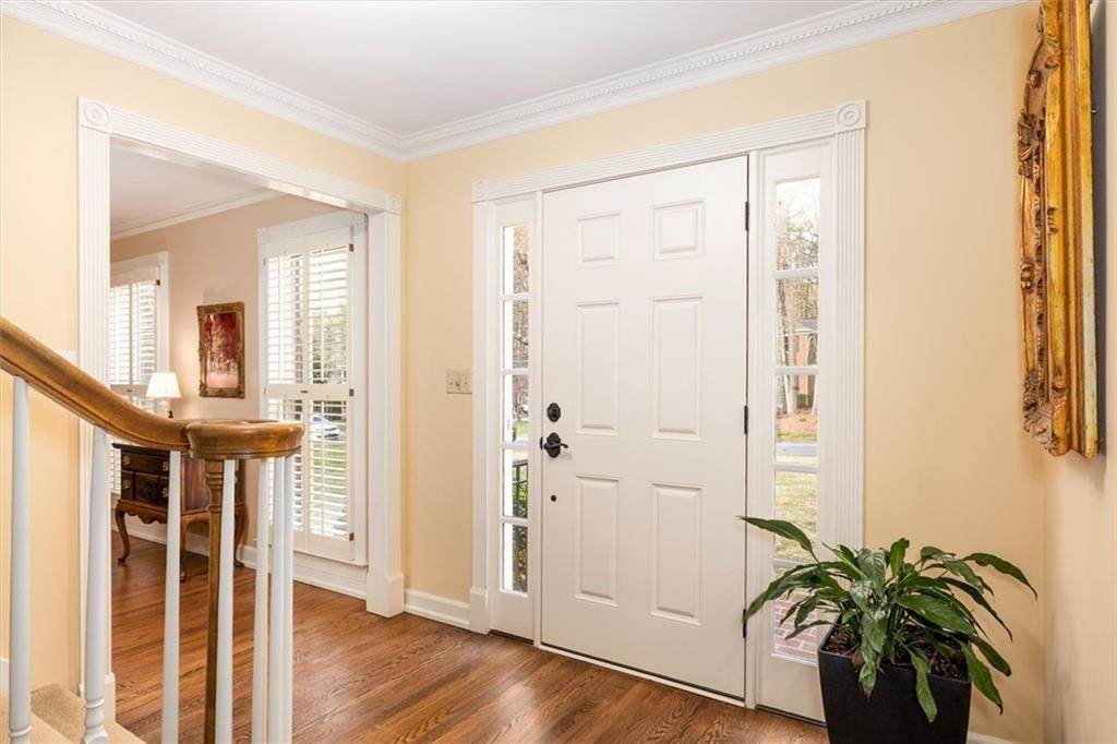 4890 Forestglade Court Smoke Rise, GA 30087 - Photo 9 of 50 a view of a hallway with wooden floor and stairs
