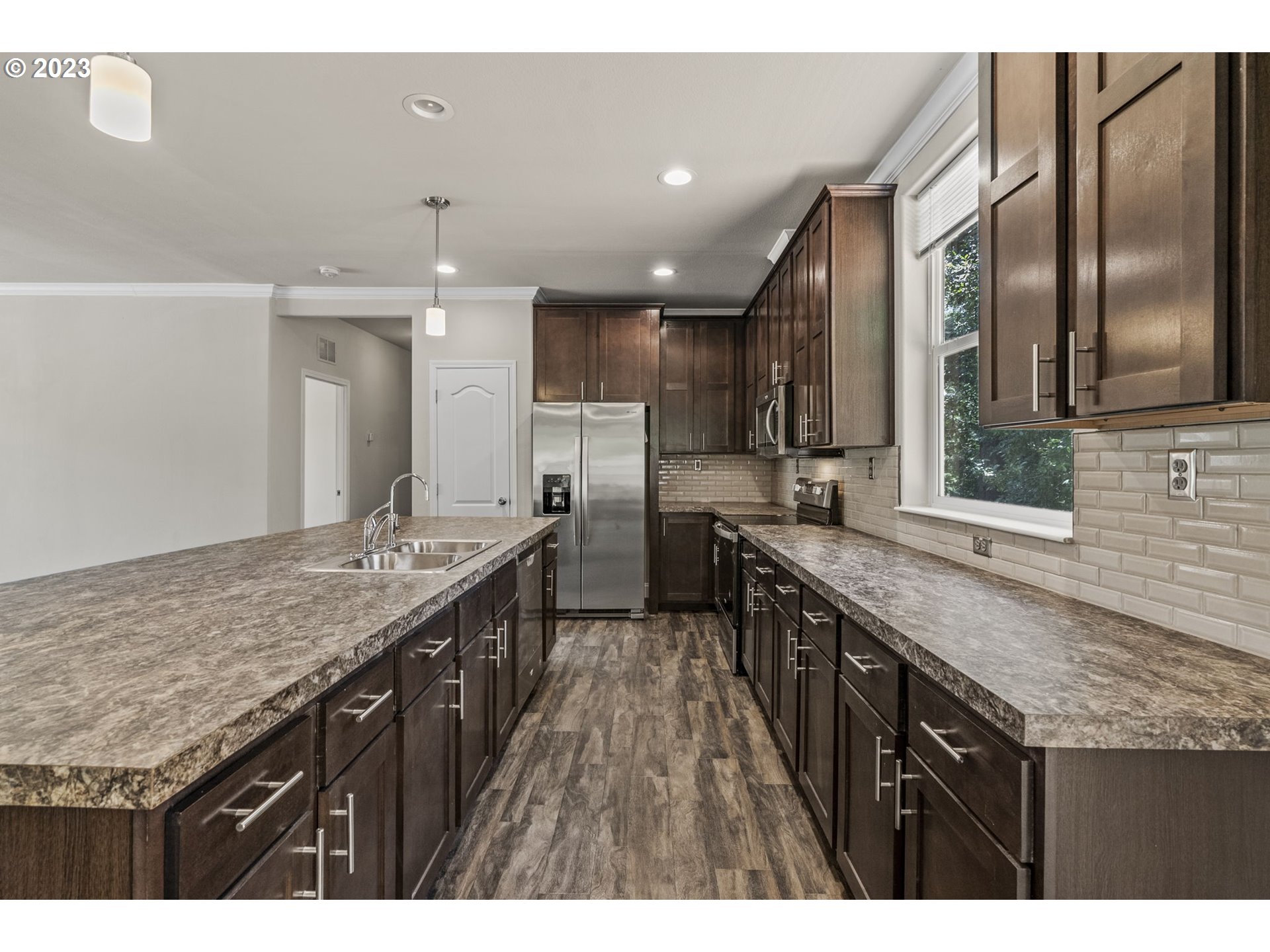 157 P G Sweet Road Kelso, WA 98626 - Photo 10 of 22 a kitchen with granite countertop kitchen island stainless steel appliances a sink stove and cabinets