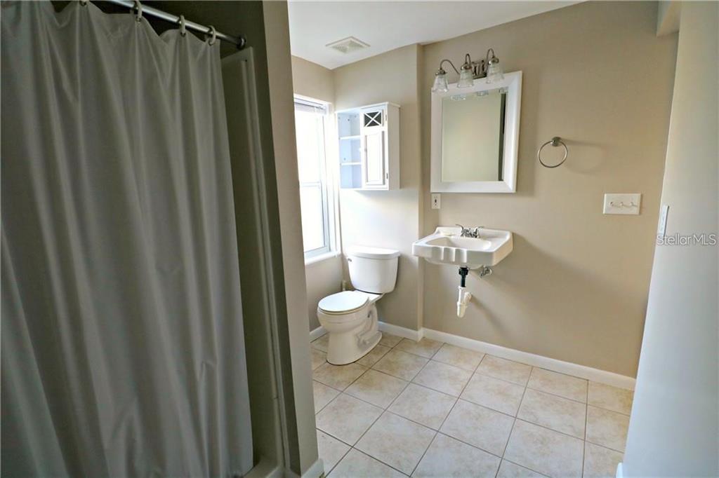 1222 St Anne Shrine Road Lake Wales, FL 33898 - Photo 12 of 14 a bathroom with a sink a toilet and shower curtain