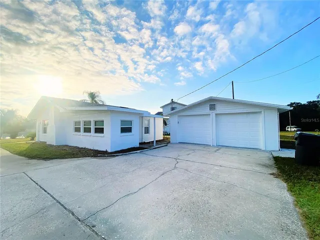 a view of a house with a yard and garage