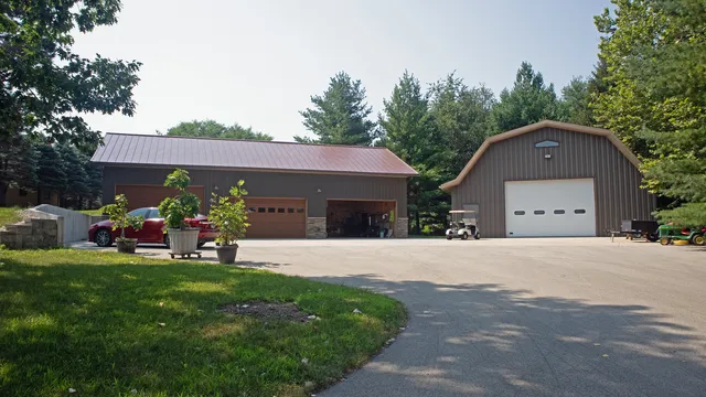 a front view of a house with a garden and trees