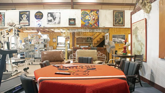 a room with furniture a flat screen tv and a table