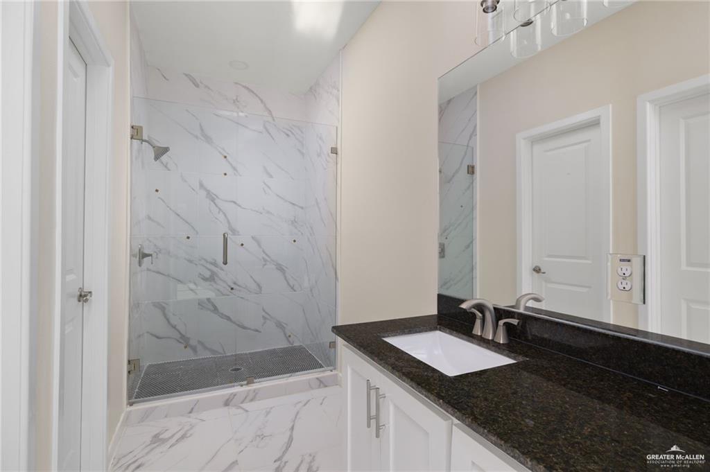 616 Mountain Road, Unit 5C Mission, TX 78573 - Photo 7 of 10 a bathroom with a granite countertop sink and a mirror
