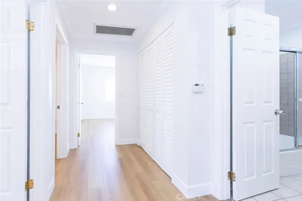 a view of a hallway with wooden floor