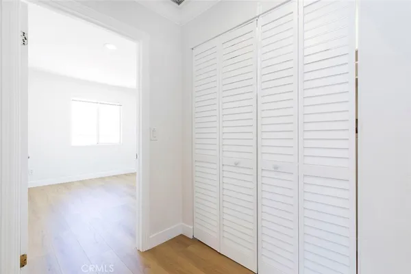 a view of a room with wooden floor