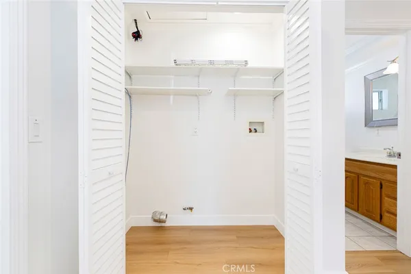 a view of walk in closet with white walls