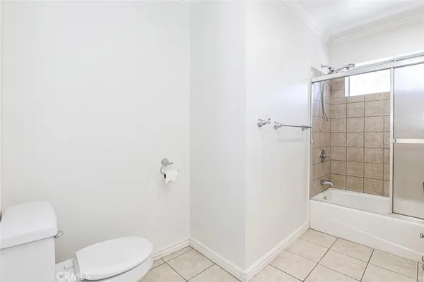 a bathroom with a toilet and shower