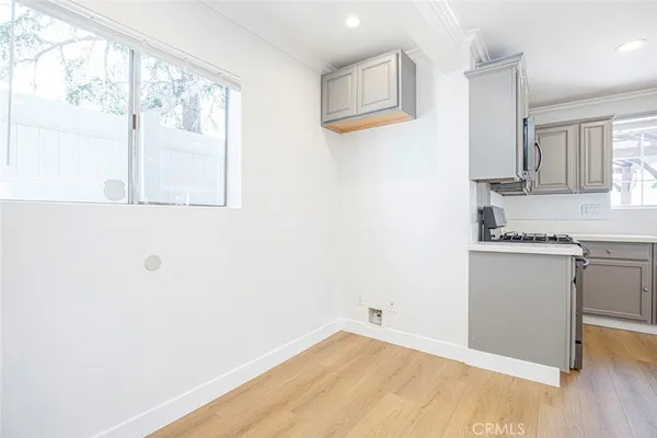 a view of a kitchen with wooden floor and a window