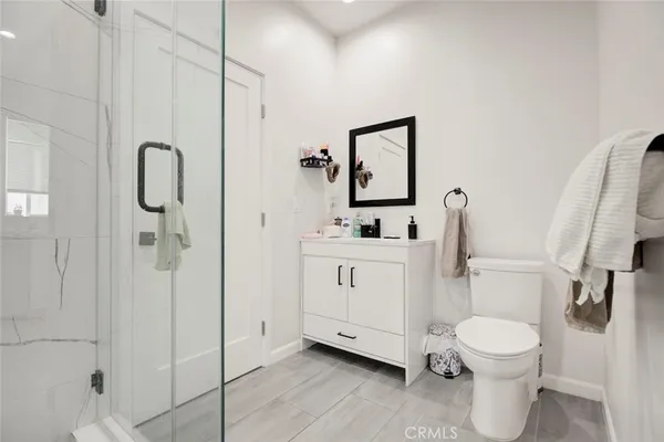 a bathroom with a toilet sink and shower
