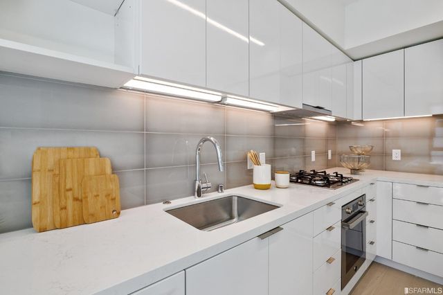 a kitchen with a sink and cabinets