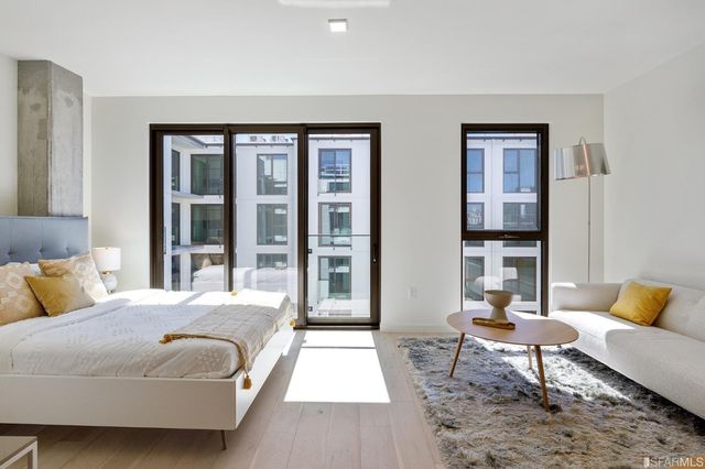 a bedroom with a bed a lamp and window